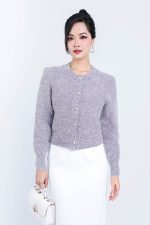 High-end fashion shimmer sweater with round neck and decorative stone buttons