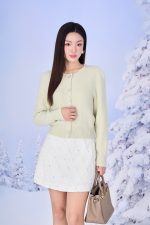 High-end fashion shimmer sweater with round neck and decorative stone buttons
