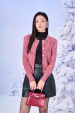 High-end fashion shimmer sweater with round neck and decorative stone buttons