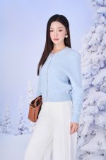 High-end fashion shimmer sweater with round neck and decorative stone buttons