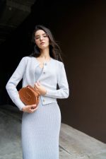 High-end fashion shimmer sweater with round neck and decorative stone buttons