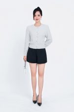 High-end fashion shimmer sweater with round neck and decorative stone buttons