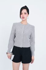 High-end fashion shimmer sweater with round neck and decorative stone buttons
