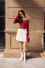 High-end fashion sweater with off-the-shoulder shape, flared sleeves and front zip