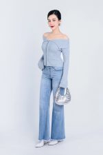 High-end fashion sweater with off-the-shoulder shape, flared sleeves and front zip