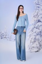 High-end fashion sweater with off-the-shoulder shape, flared sleeves and front zip