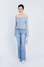 High-end fashion sweater with off-the-shoulder shape, flared sleeves and front zip
