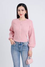 High-end fashion sweater with round neck, slightly puffed sleeves and buttoned front