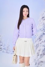 High-end fashion sweater with round neck, slightly puffed sleeves and buttoned front