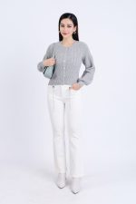 High-end fashion sweater with round neck, slightly puffed sleeves and buttoned front