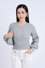 High-end fashion sweater with round neck, slightly puffed sleeves and buttoned front
