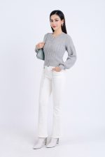 High-end fashion sweater with round neck, slightly puffed sleeves and buttoned front