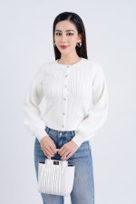 High-end fashion sweater with round neck, slightly puffed sleeves and buttoned front