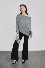 High-end sweater with crew neck, batwing sleeves and fashionable asymmetrical hem