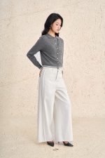 High-end sweater with V-neck, long sleeves, and striped hem to create a button-front style
