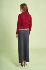 High-end sweater with V-neck, long sleeves, and striped hem to create a button-front style