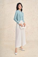 High-end sweater with V-neck, long sleeves, and striped hem to create a button-front style