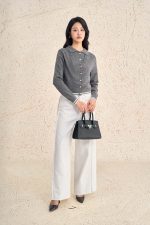 High-end sweater with V-neck, long sleeves, and striped hem to create a button-front style