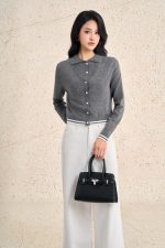 High-end sweater with V-neck, long sleeves, and striped hem to create a button-front style