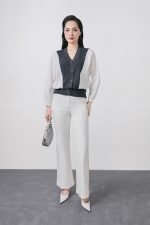 High-quality knitted sweater with V-neck, loose shape, batwing sleeves, buttoned body, styled with elastic hem