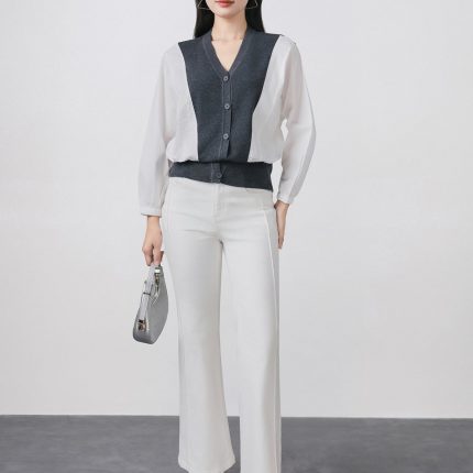 High-quality knitted sweater with V-neck, loose shape, batwing sleeves, buttoned body, styled with elastic hem