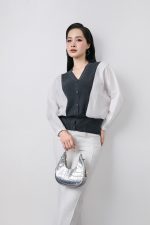High-quality knitted sweater with V-neck, loose shape, batwing sleeves, buttoned body, styled with elastic hem