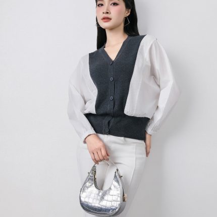 High-quality knitted sweater with V-neck, loose shape, batwing sleeves, buttoned body, styled with elastic hem
