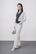 High-quality knitted sweater with V-neck, loose shape, batwing sleeves, buttoned body, styled with elastic hem