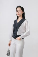 High-quality knitted sweater with V-neck, loose shape, batwing sleeves, buttoned body, styled with elastic hem