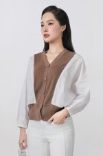 High-quality knitted sweater with V-neck, loose shape, batwing sleeves, buttoned body, styled with elastic hem