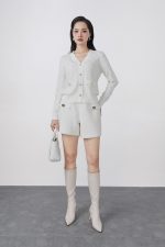 High-quality knitted sweater with V-neck, plaid pattern, and fashionable stone buttons with pockets